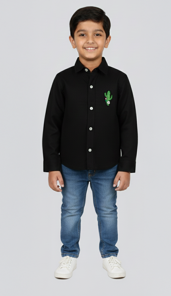 Child wearing a black shirt with a cactus design and blue jeans on a white background