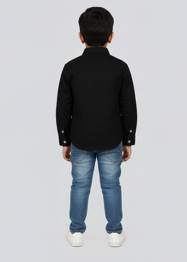 Child wearing a black shirt and blue jeans on a white background