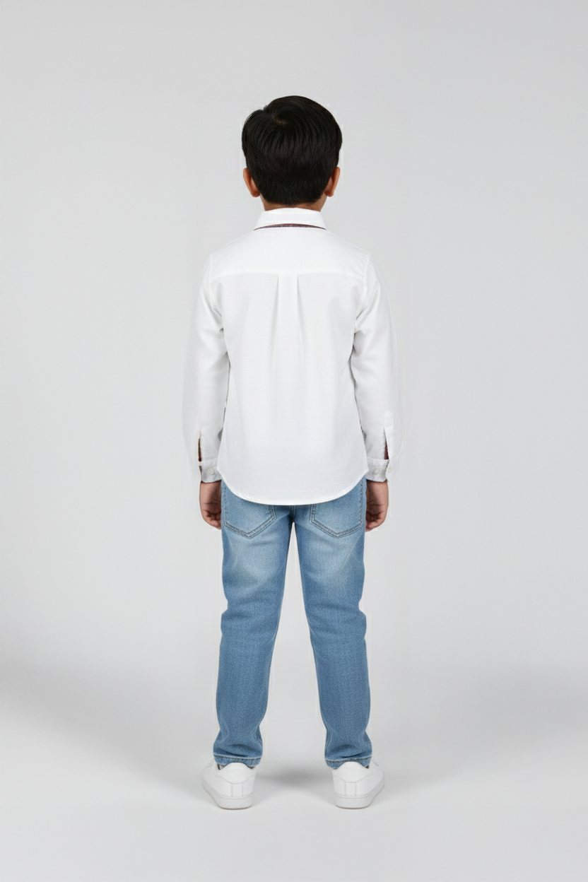 Person wearing a white shirt and light blue jeans on a plain background